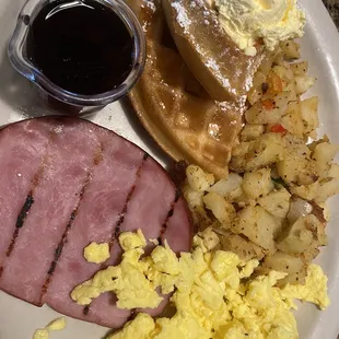 Half waffle, ham, scrambled eggs and country potatoes.