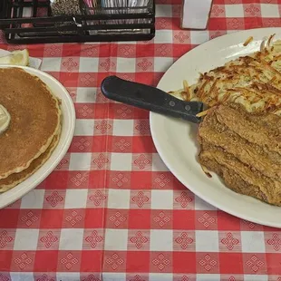 Country fried steak, hasbrowns, scrambled eggs, and pancakes.