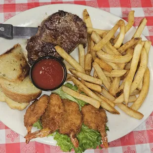 Steak and shrimp with French fries and garlic bread toast. Came with a dude of fruit, not in picture.