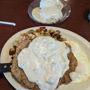 Chicken fried steak breakfast with country potatoes and biscuits and gravy!