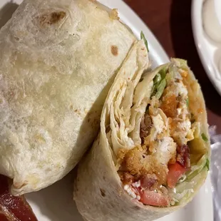 a burrito and bacon on a plate