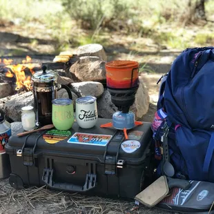 the contents of a backpack, a can of beer, a can of soda, and a