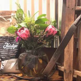 a vase of flowers on a shelf