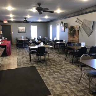 a large conference room with tables and chairs