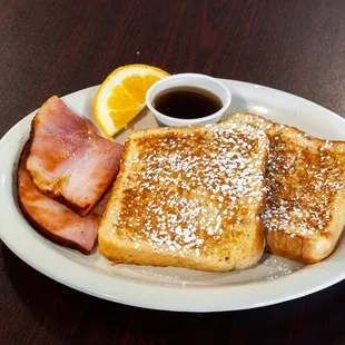 a plate of french toast and bacon