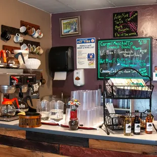 a coffee bar with a menu on the wall