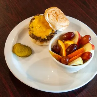a plate of food with a sandwich and pickles