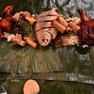 a plate of food on a banana leaf