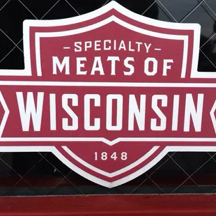 a red and white sign with the words specialty meats of wisconsin