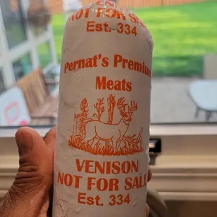 a person holding a bag of meat