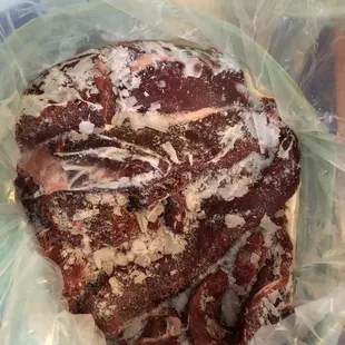 Meat covered in ice crystals in a giant block