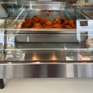 a pan of chicken wings in the oven