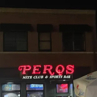 a car parked in front of a sports bar