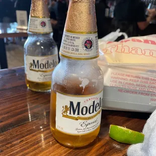 two bottles of modell beer on a bar