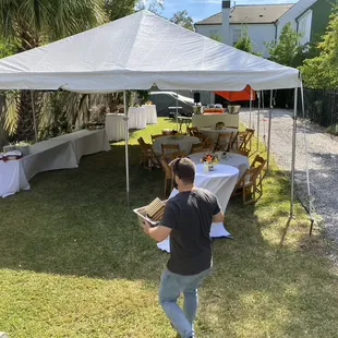 Tables, chairs, linens, bar, plates, glasses, flatware by Perrier Party Rental/