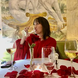 a woman drinking a glass of wine