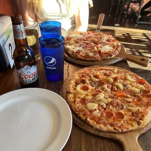 two pizzas on a table