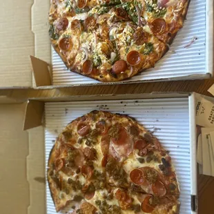 two pizzas in boxes