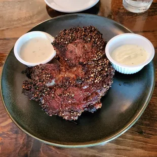 22oz Ribeye served Au Poivre. Blackened with peppercorns and a creamy cognac sauce