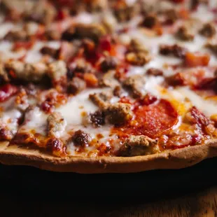 a pizza with meat and cheese