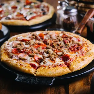 two pizzas on a table