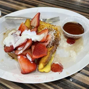 French toast with fresh strawberries, and whipped cream