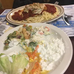 a plate of pasta, salad, and chicken