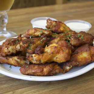 Our Fresh Crispy Wings our awesome! Give it a try:) 
Owner suggestion get it well done.