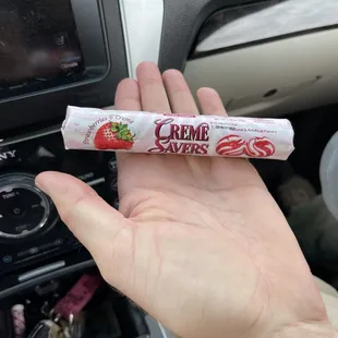 a hand holding a tube of cream