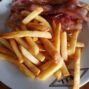 2 eggs with bacon and French fries. February 2023