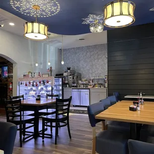 a dining area with tables and chairs