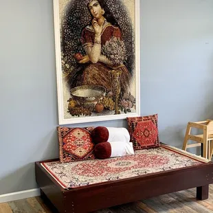 a bed with a painting on the wall