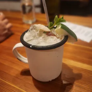 a cup of ice cream with a lime garnish