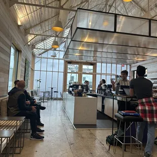 people sitting at tables in a restaurant