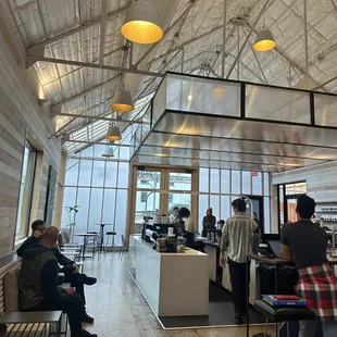 people sitting at tables in a restaurant