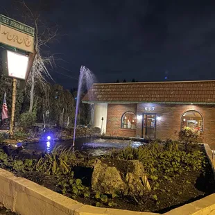 a fountain in front of a restaurant