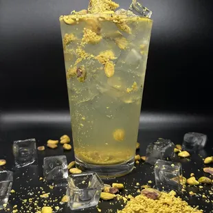 a glass of lemonade with ice cubes