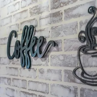 a brick wall with coffee signs