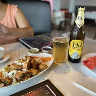 a plate of food and a bottle of beer