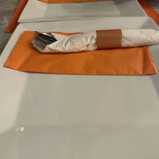 a table setting with napkins and utensils