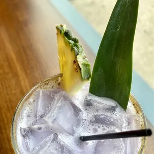 a drink with a pineapple garnish