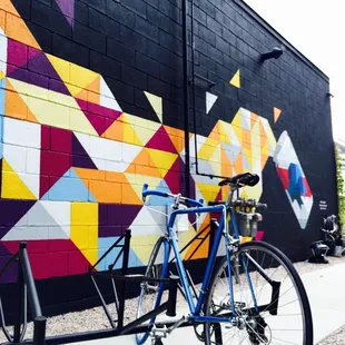 a bicycle parked against a colorful wall