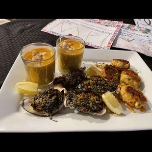 Shellfish Trio: Mini Crab Cakes, cajun remoulade, lobster bisque shooters, and oysters rockefeller