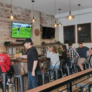 a group of people sitting at a bar