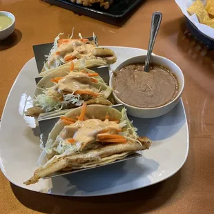 Tilapia Fish Taco on corn tortilla with refried beans