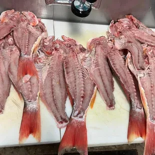 a bunch of fish on a cutting board