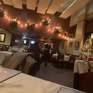 a restaurant with a christmas tree in the background