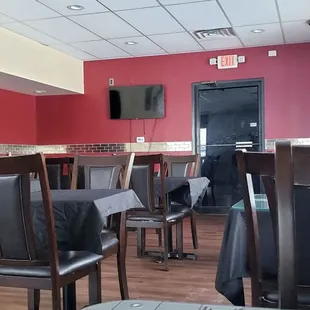 a view of a restaurant with tables and chairs