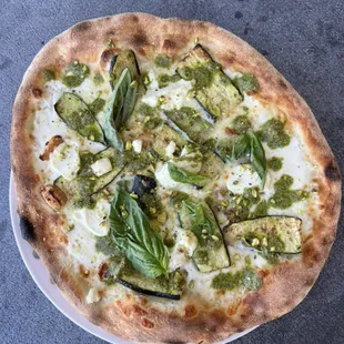 Herb garden zucchini, pizza topped with pistachios and pesto and fresh basil. Amazing and delicious.