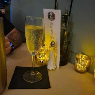 a glass of wine and a menu